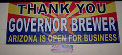 Banners urging Brewer to veto the bill were quickly swapped for signs praising her decision.
